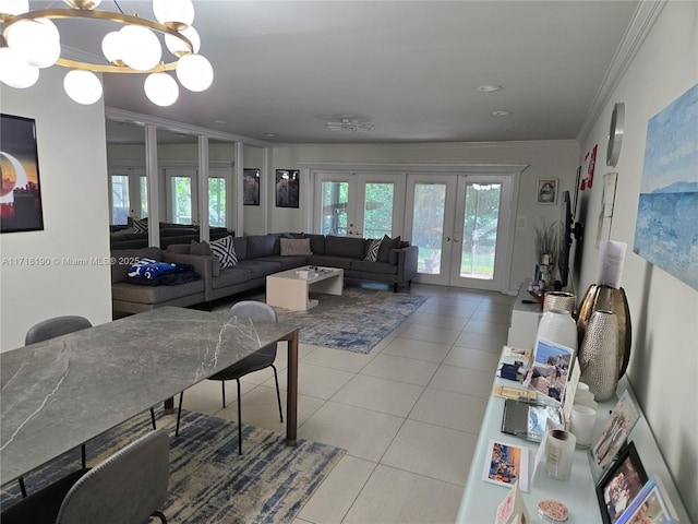 living room featuring a wealth of natural light, french doors, crown molding, a chandelier, and light tile patterned floors