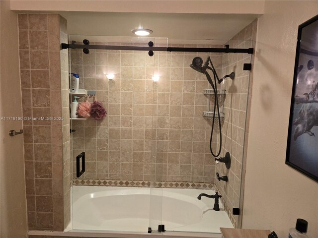 bathroom with bath / shower combo with glass door