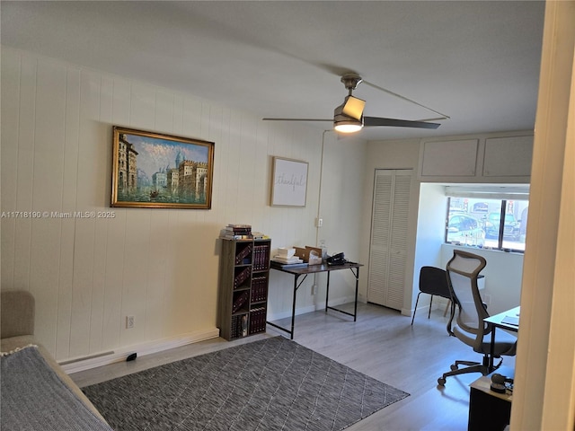 home office featuring light hardwood / wood-style flooring and ceiling fan