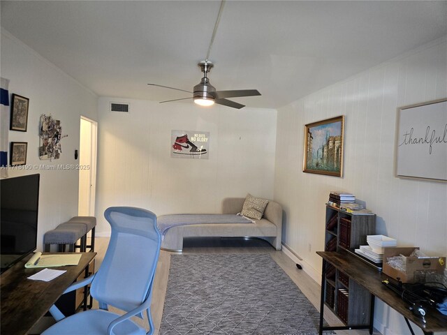 home office with ceiling fan and hardwood / wood-style floors