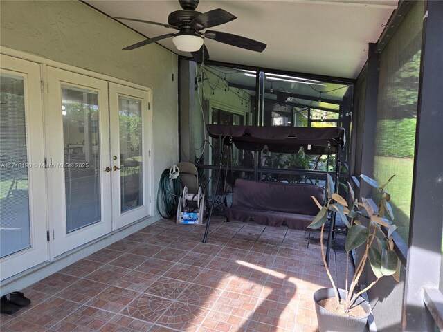 sunroom / solarium with ceiling fan and french doors