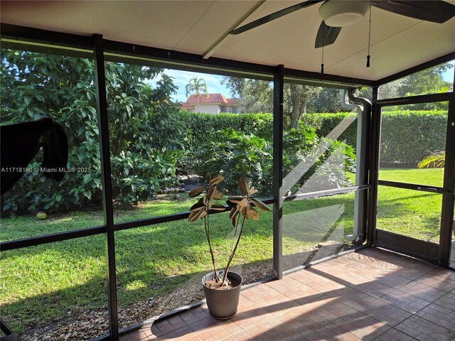 unfurnished sunroom featuring a wealth of natural light and ceiling fan