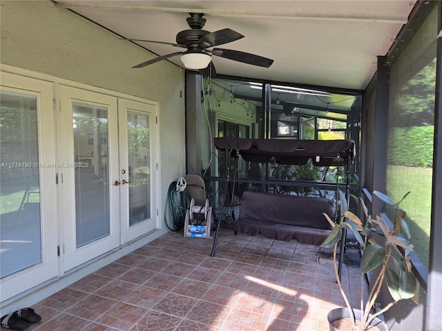 sunroom / solarium featuring french doors and ceiling fan