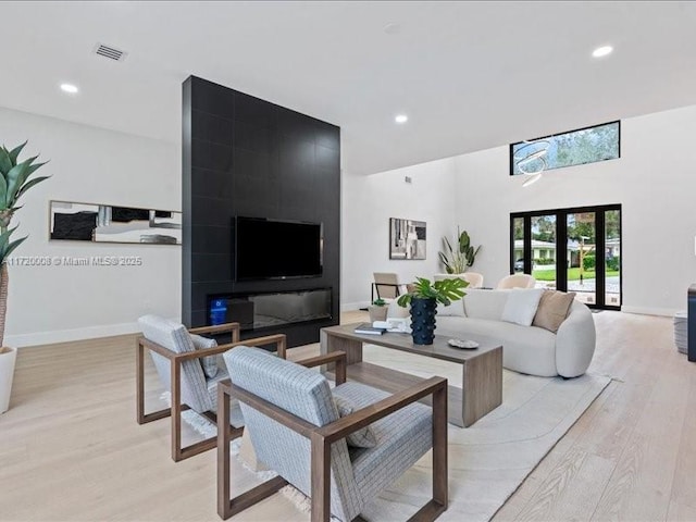 living room featuring light wood-type flooring and french doors