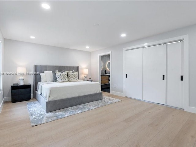 bedroom with a closet and light hardwood / wood-style floors