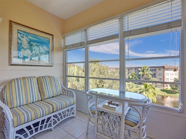 sunroom / solarium featuring a water view