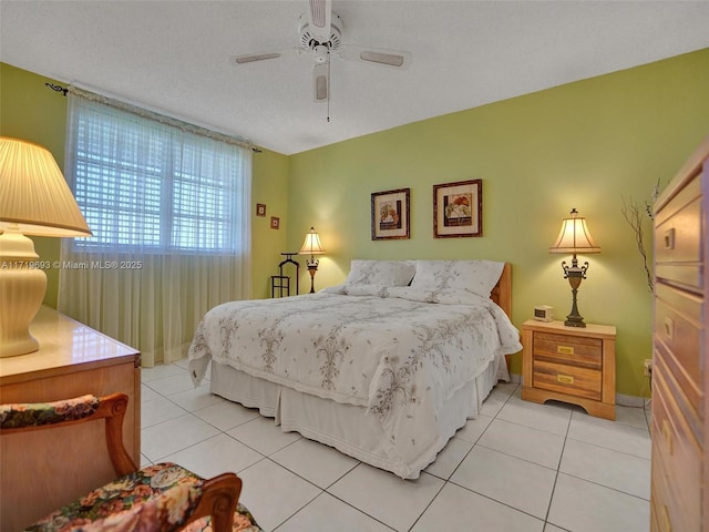 tiled bedroom featuring ceiling fan