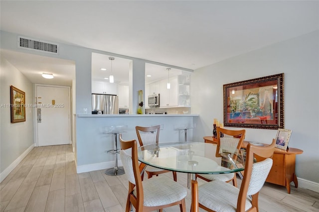 dining space featuring light hardwood / wood-style flooring