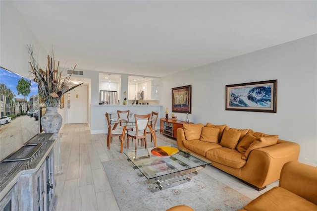 living room with light hardwood / wood-style flooring