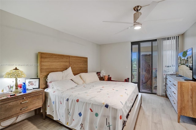 bedroom featuring ceiling fan, access to exterior, a wall of windows, and light hardwood / wood-style flooring