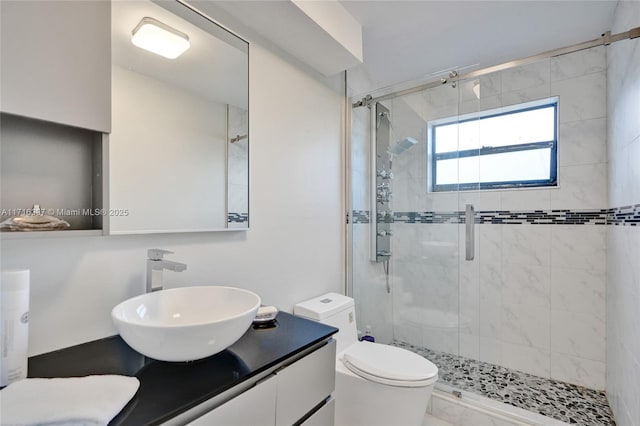 bathroom with vanity, toilet, and a shower with door