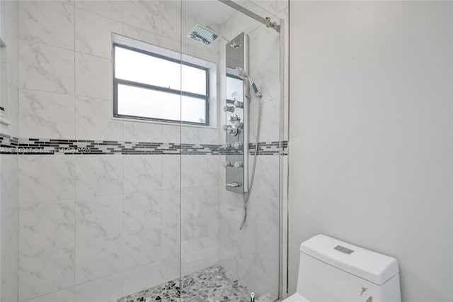 bathroom with an enclosed shower and toilet