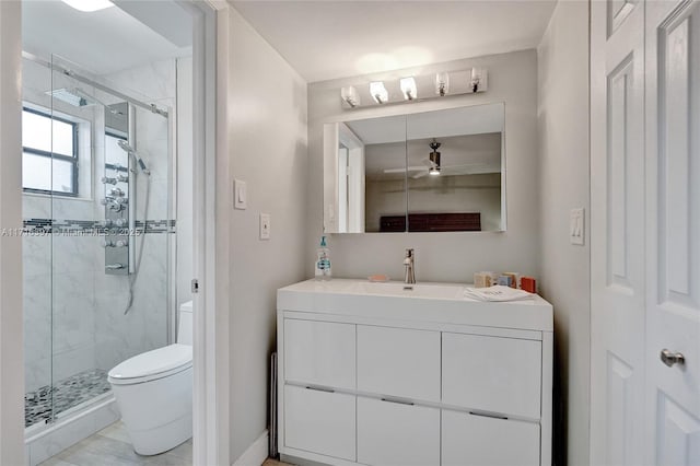 bathroom featuring vanity, toilet, and a shower with shower door