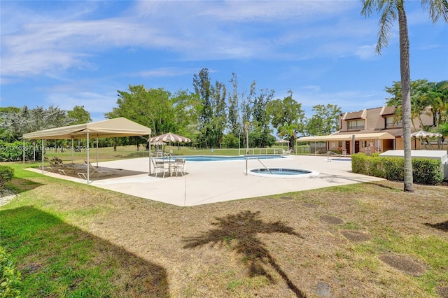 view of pool featuring a lawn and a patio area