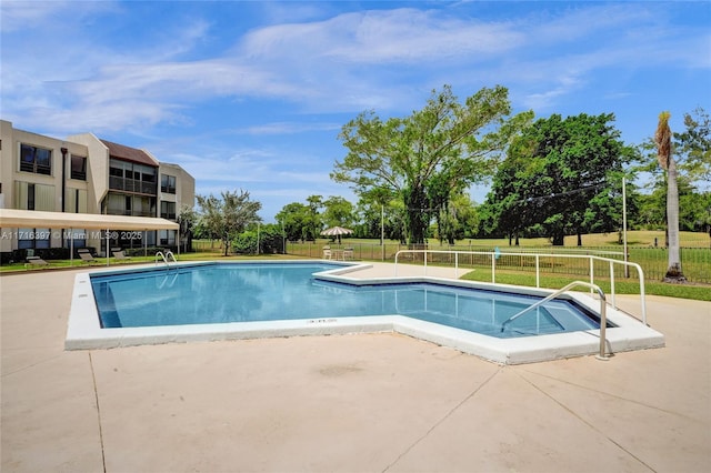 view of pool featuring a lawn