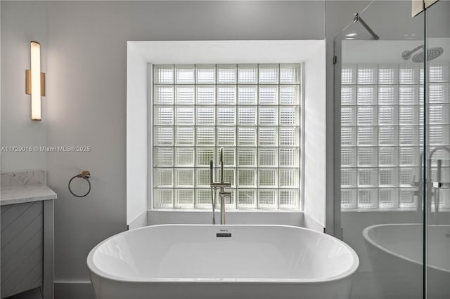 bathroom featuring vanity and shower with separate bathtub