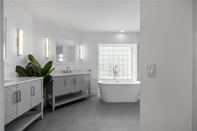 bathroom featuring a washtub and vanity