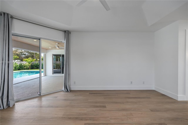 empty room featuring ceiling fan and light hardwood / wood-style floors