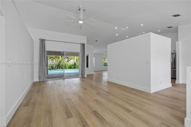 unfurnished living room featuring ceiling fan and light hardwood / wood-style floors