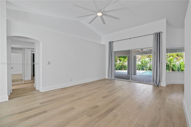 empty room with ceiling fan, lofted ceiling, and light wood-type flooring