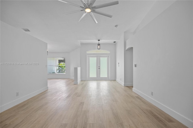 unfurnished living room featuring ceiling fan, light wood-type flooring, and french doors