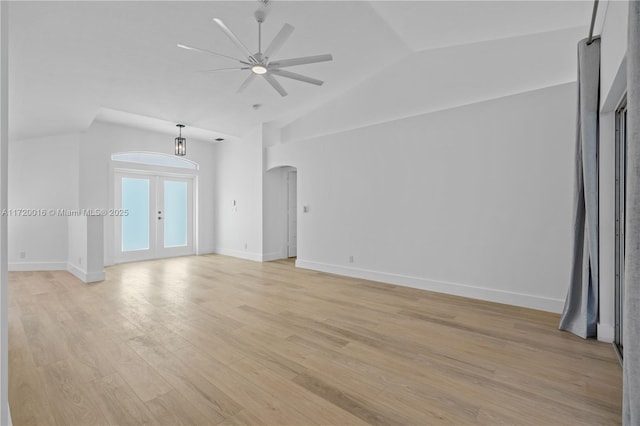 unfurnished room featuring french doors, light hardwood / wood-style floors, ceiling fan, and lofted ceiling