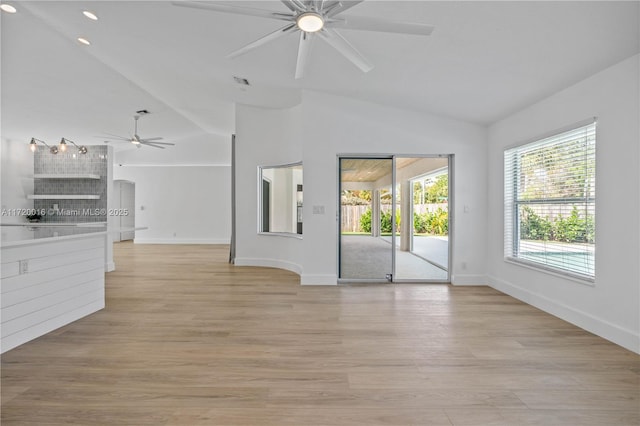 unfurnished living room featuring ceiling fan, light hardwood / wood-style flooring, and vaulted ceiling