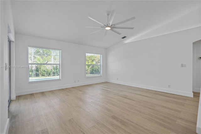 unfurnished room featuring ceiling fan, light hardwood / wood-style floors, and vaulted ceiling