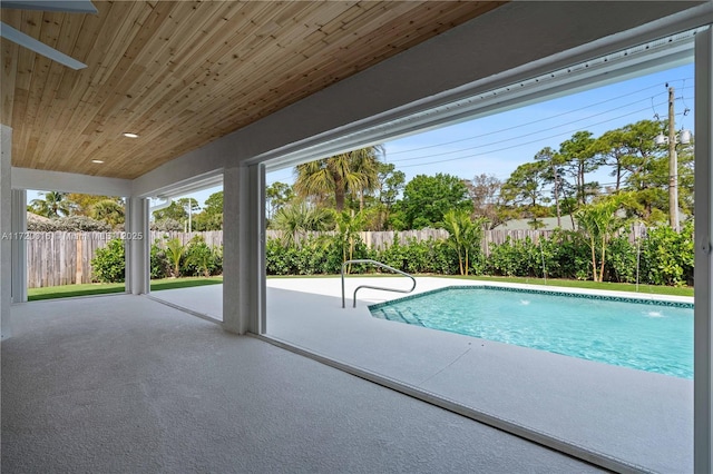 view of pool with ceiling fan, pool water feature, and a patio