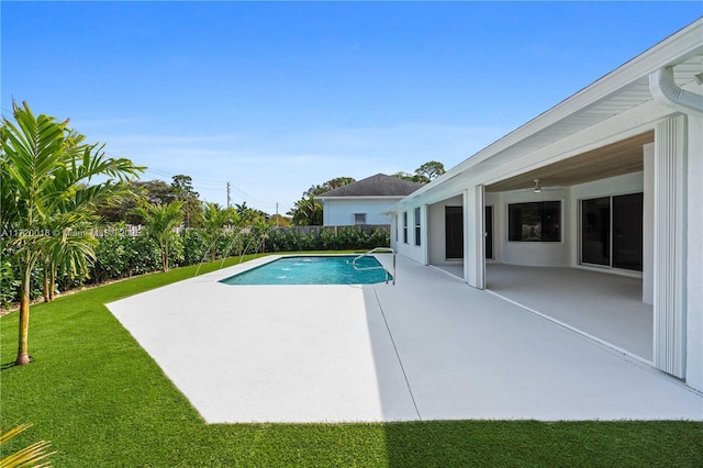 view of pool featuring a lawn and a patio area