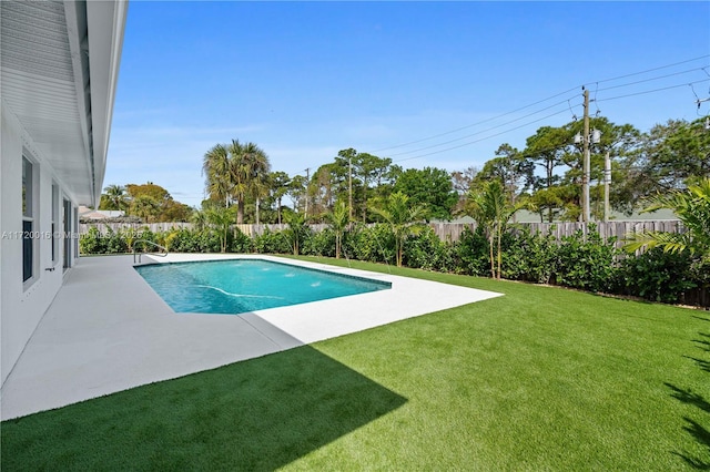 view of swimming pool with a yard and a patio