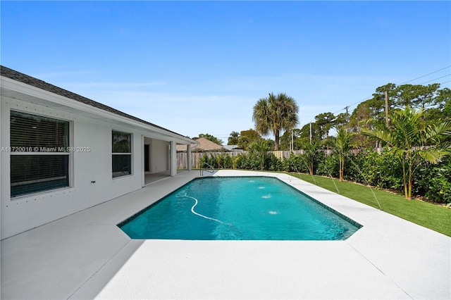 view of swimming pool featuring a yard and a patio