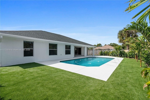 view of pool featuring a lawn and a patio area