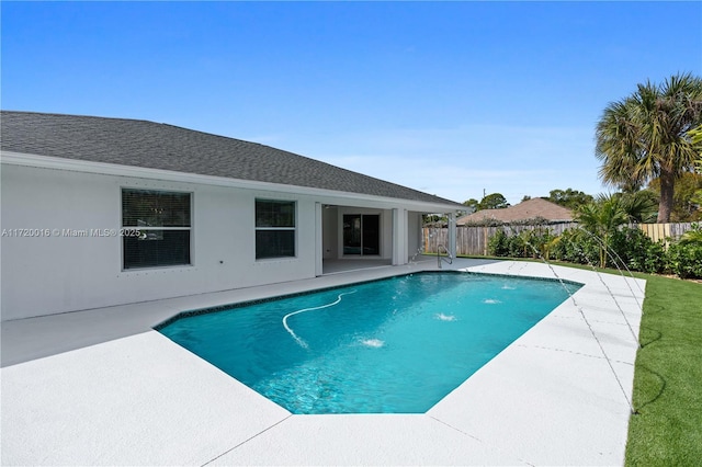 view of swimming pool featuring pool water feature and a patio area