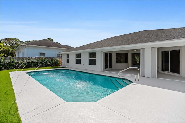 view of pool with pool water feature and a patio