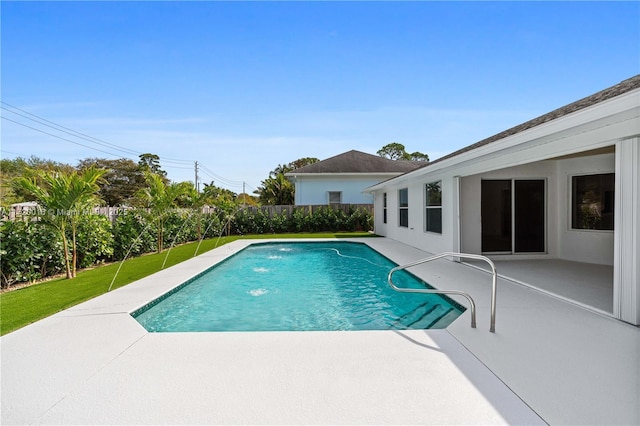 view of pool featuring pool water feature, a yard, and a patio