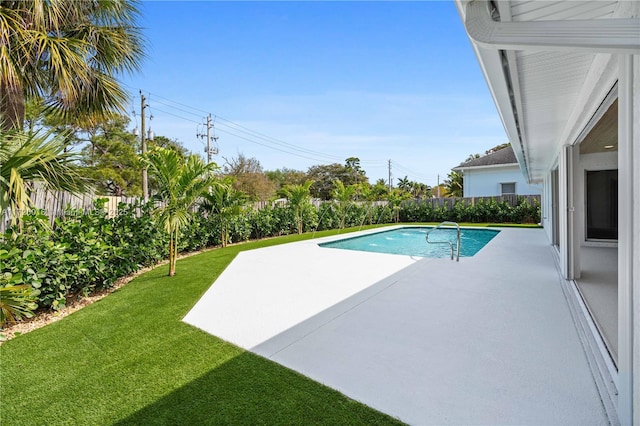 view of pool with a yard and a patio area