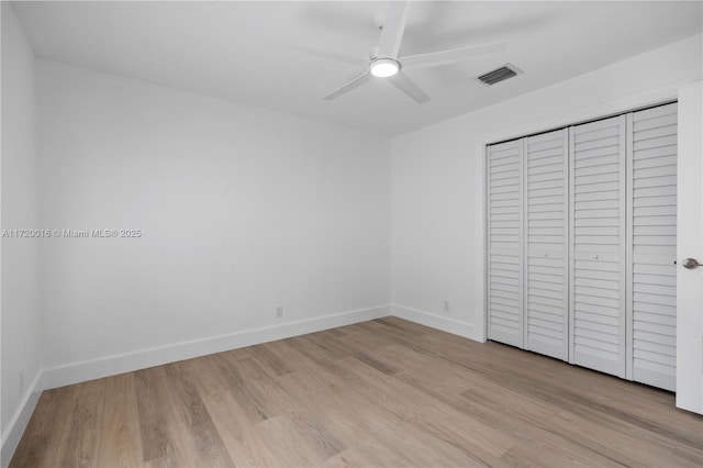 unfurnished bedroom featuring a closet, ceiling fan, and light hardwood / wood-style flooring