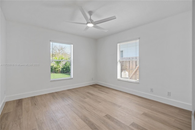 empty room with light hardwood / wood-style flooring, plenty of natural light, and ceiling fan