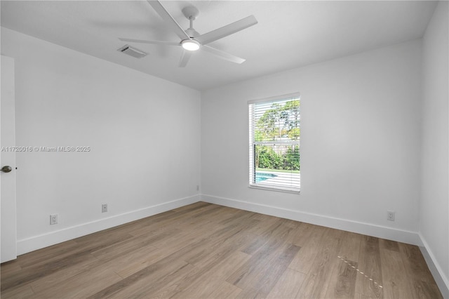 empty room with ceiling fan and light hardwood / wood-style floors