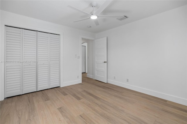 unfurnished bedroom with a closet, light hardwood / wood-style flooring, and ceiling fan