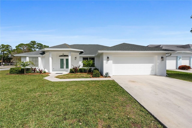 ranch-style house featuring a garage, a front yard, and french doors