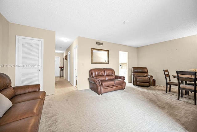 living room with light carpet and a textured ceiling