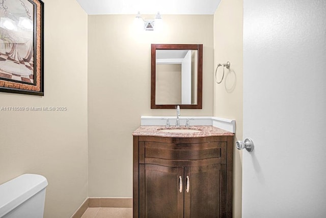 bathroom with tile patterned floors, vanity, and toilet