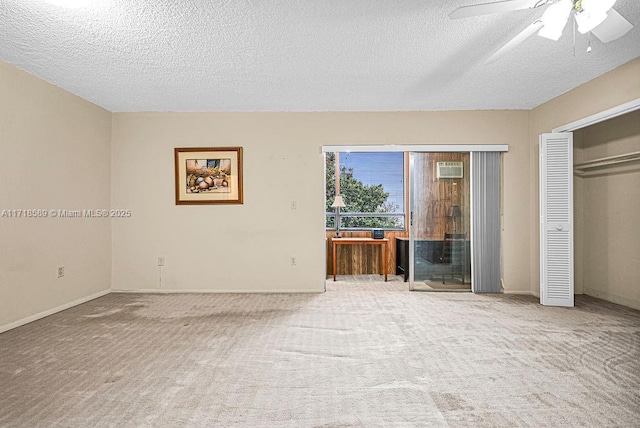 interior space featuring a textured ceiling, carpet floors, a closet, and ceiling fan