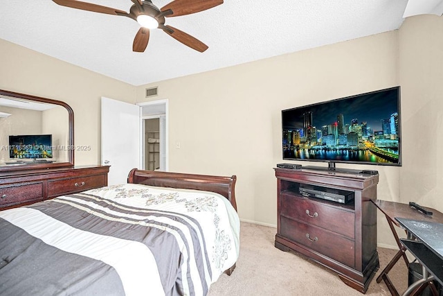 bedroom featuring ceiling fan and light carpet