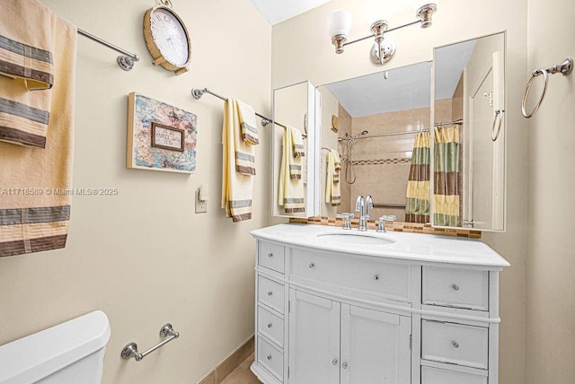 bathroom featuring vanity, toilet, and walk in shower