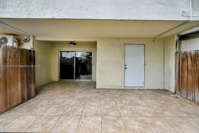 doorway to property with a patio area and ceiling fan