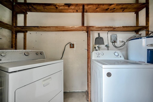 washroom featuring washing machine and dryer and electric water heater