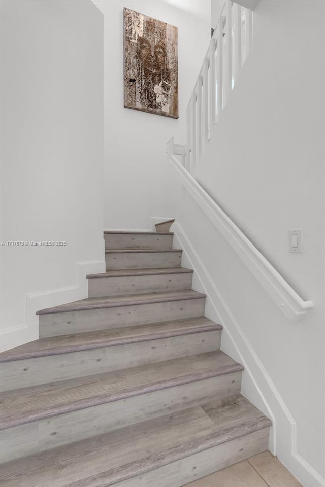 staircase with tile patterned flooring